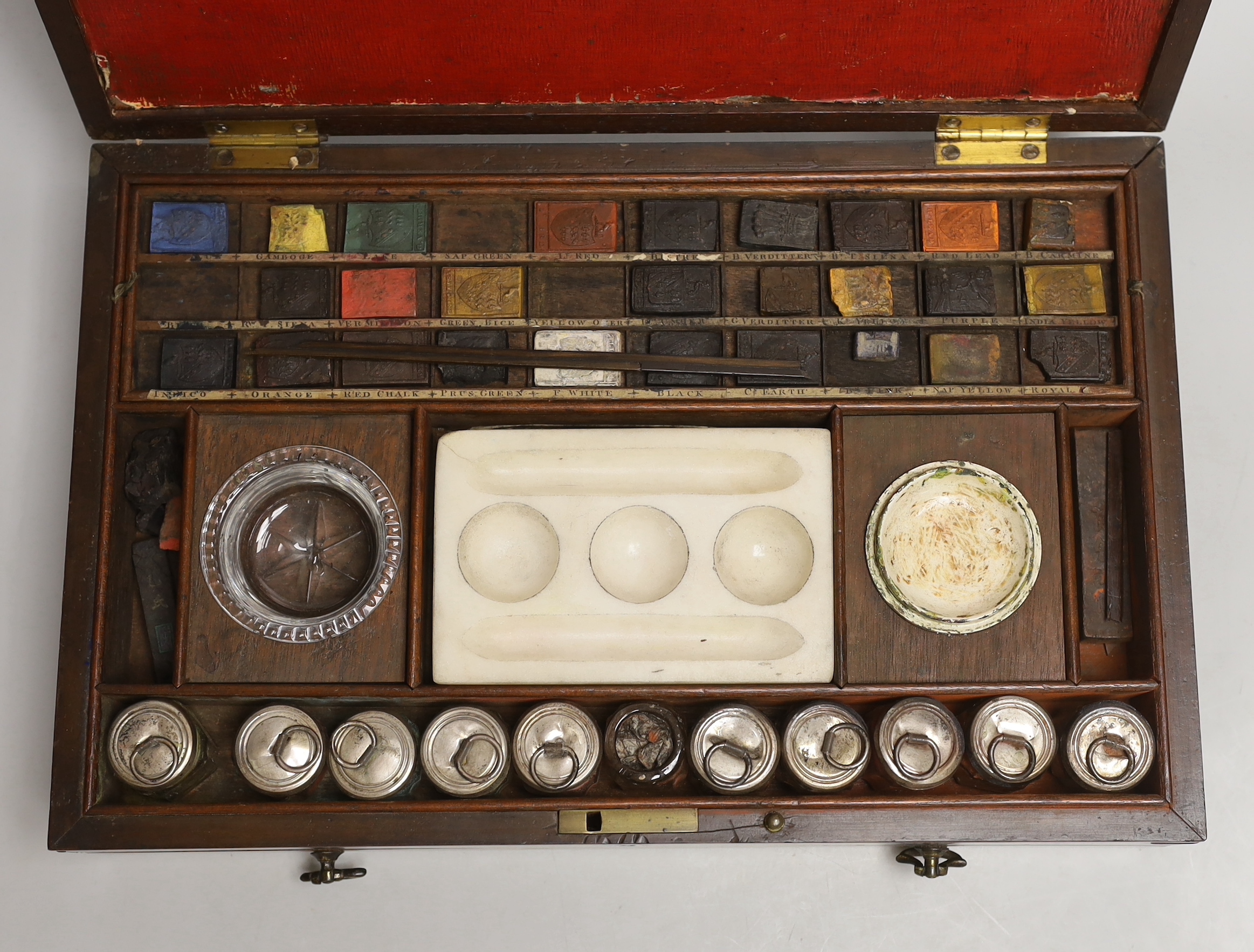 An early 19th century Reeves & Woodyer watercolourist's boxed set with fitted drawer and watercolour blocks and powder, 38cm wide